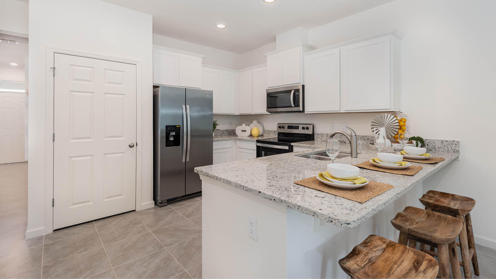 3435 Morrow Place Mims, FL 32754 - Photo 8 of 42 a kitchen with stainless steel appliances granite countertop a sink refrigerator and microwave