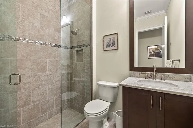 a bathroom with a granite countertop toilet sink and shower
