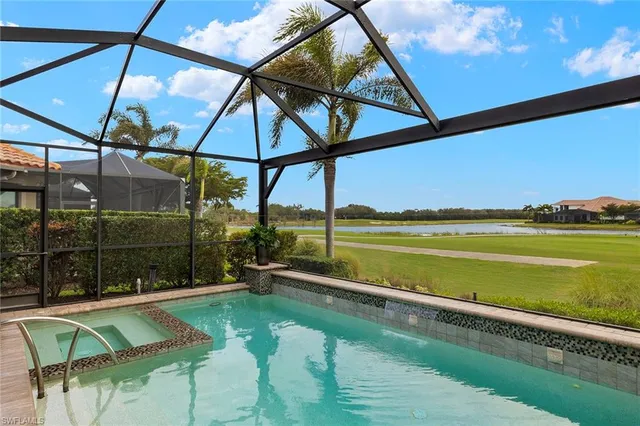 a view of a swimming pool with a patio and a yard