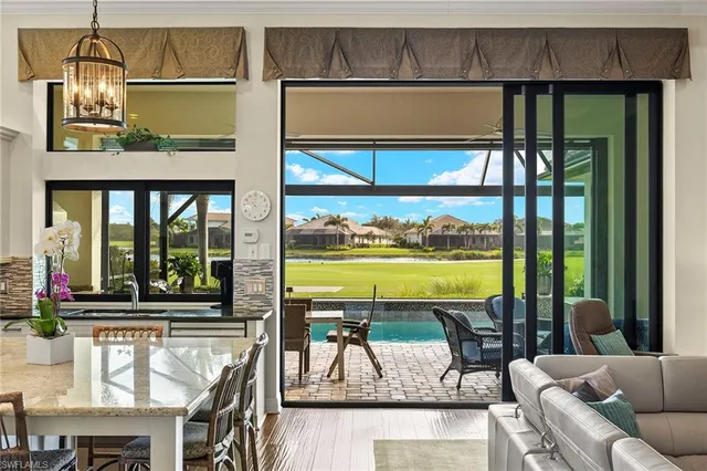 a living room with a floor to ceiling window and pool table