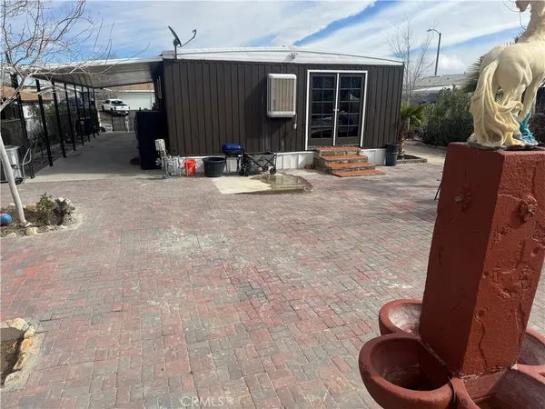 a view of roof deck with dining table and chairs with wooden fence