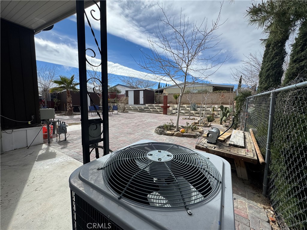 13870 Rodeo Drive Victorville, CA 92395 - Photo 17 of 22 a view of roof deck with dining table and chairs with wooden fence