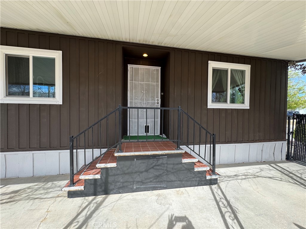 13870 Rodeo Drive Victorville, CA 92395 - Photo 4 of 22 a front view of a house with a garage