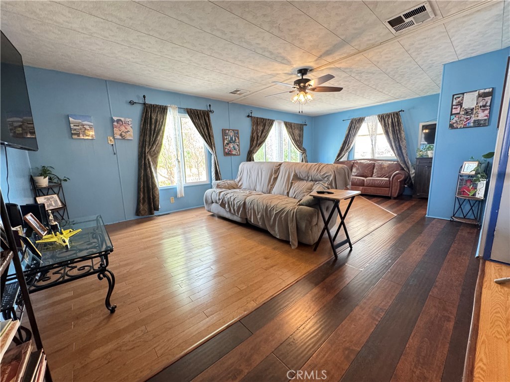 13870 Rodeo Drive Victorville, CA 92395 - Photo 9 of 22 a living room with furniture and a wooden floor