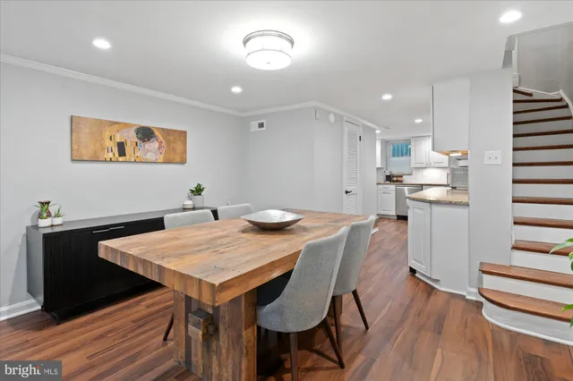 a dinning room with furniture and wooden floor