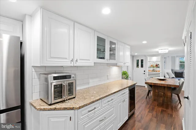 a kitchen with stainless steel appliances granite countertop a sink a stove a microwave and cabinets