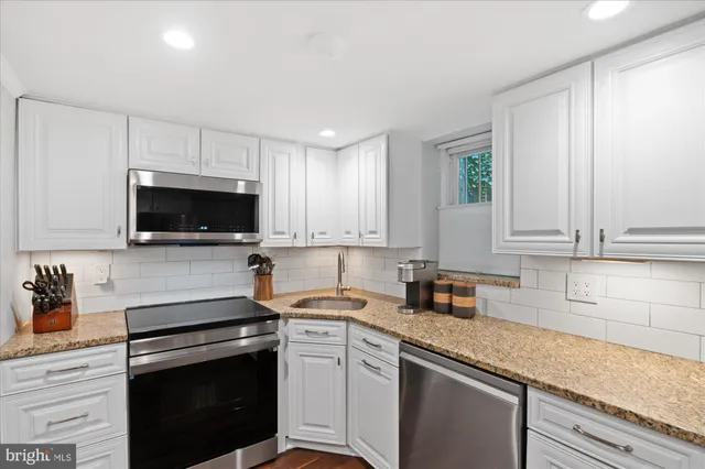 a kitchen with a sink stove and microwave