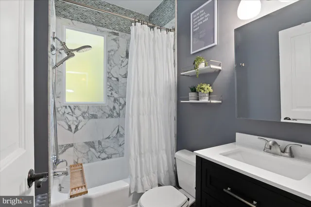 a bedroom with a bed and painting on the wall