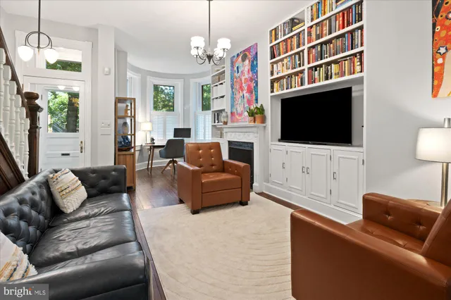 a living room with furniture fireplace and flat screen tv