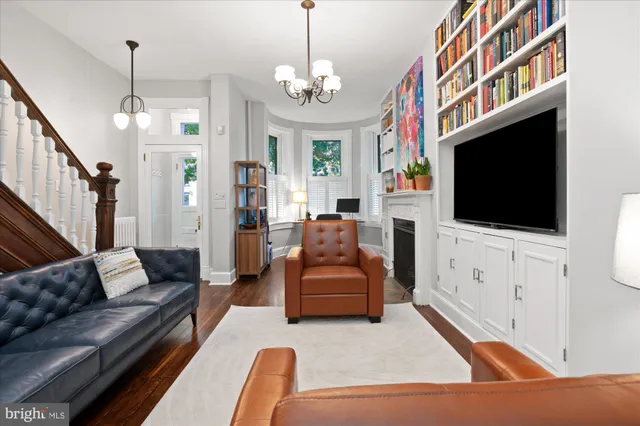 a living room with furniture chandelier and a dining table