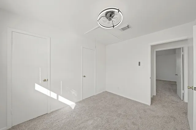 a view of a hallway with racks on the wall