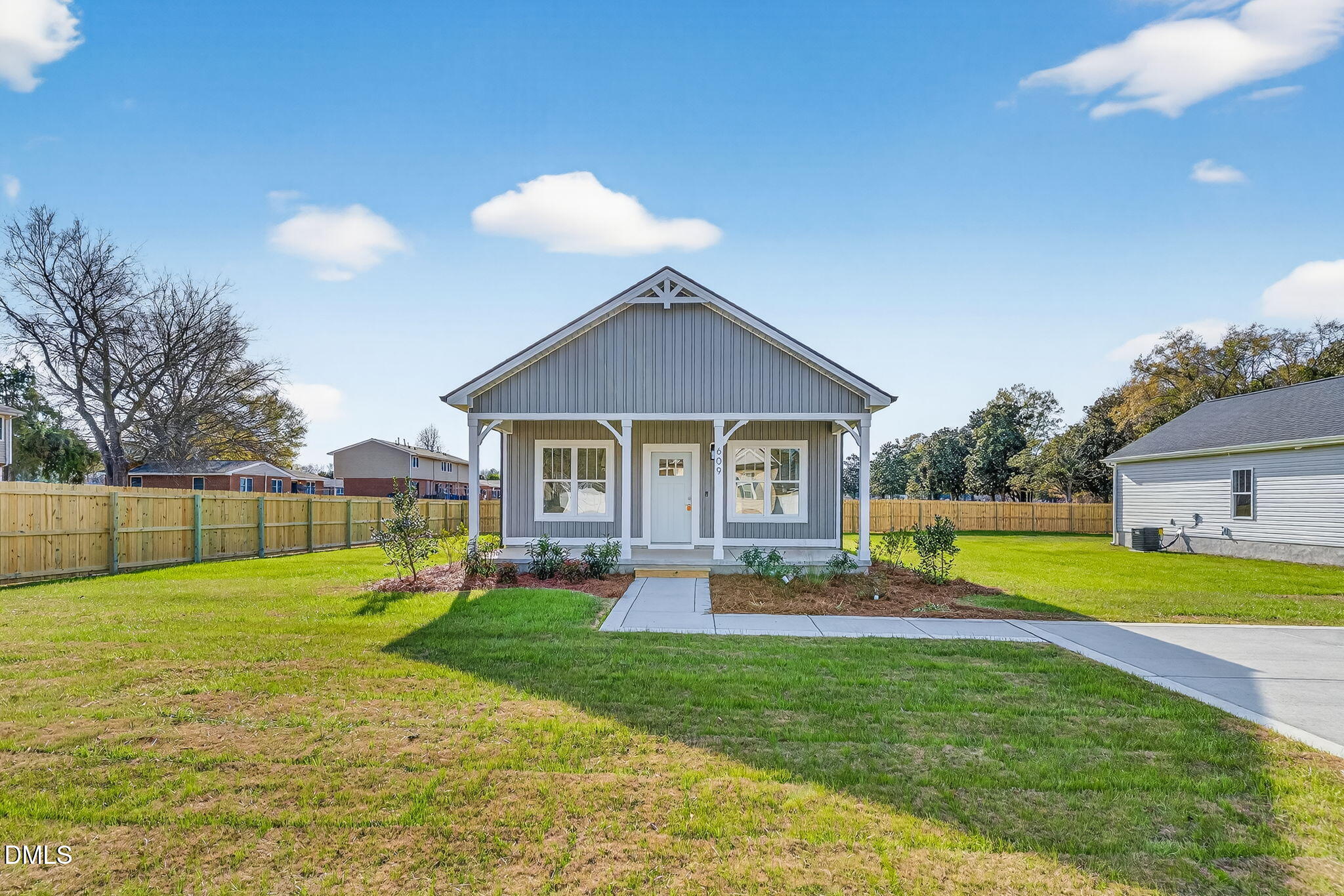 609 West Godwin Street Dunn, NC 28334 - Photo 2 of 38 a view of house with a big yard and potted plants