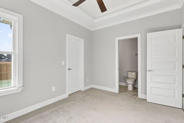 an empty room with closet and a window
