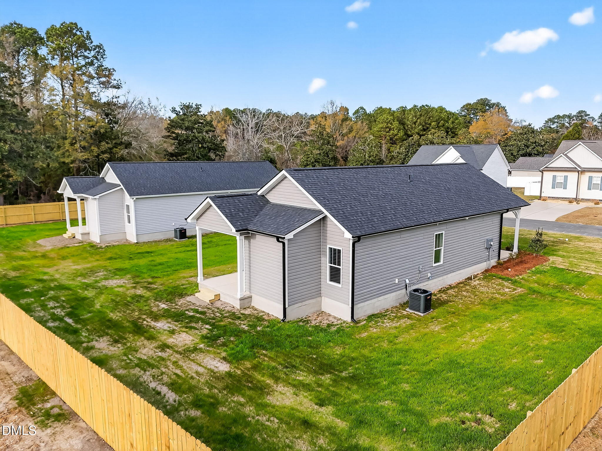 609 West Godwin Street Dunn, NC 28334 - Photo 31 of 38 a view of a house with a big yard potted plants and large tree