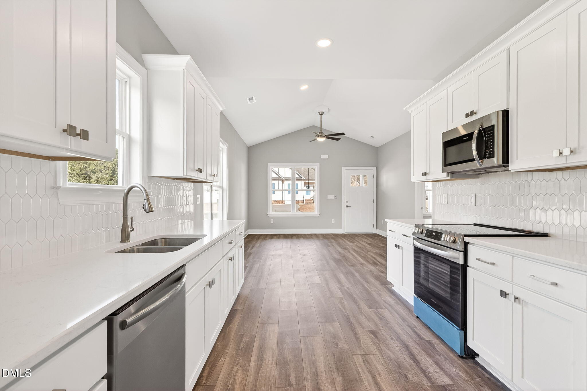 609 West Godwin Street Dunn, NC 28334 - Photo 7 of 38 a kitchen with granite countertop a sink a stove and cabinets