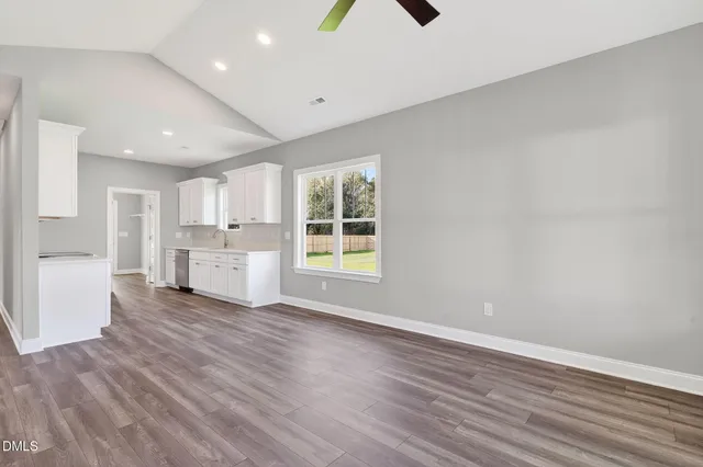 a view of a kitchen with wooden floor and windows