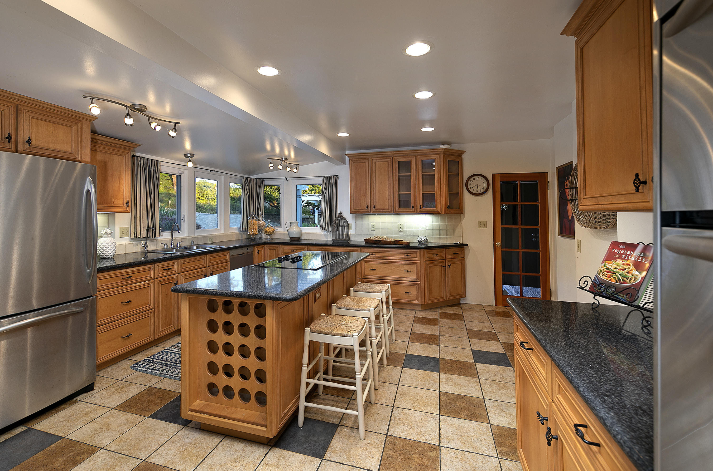 1215 High Ridge Lane Santa Barbara, CA 93103 - Photo 10 of 20 a kitchen with stainless steel appliances granite countertop a sink and a refrigerator