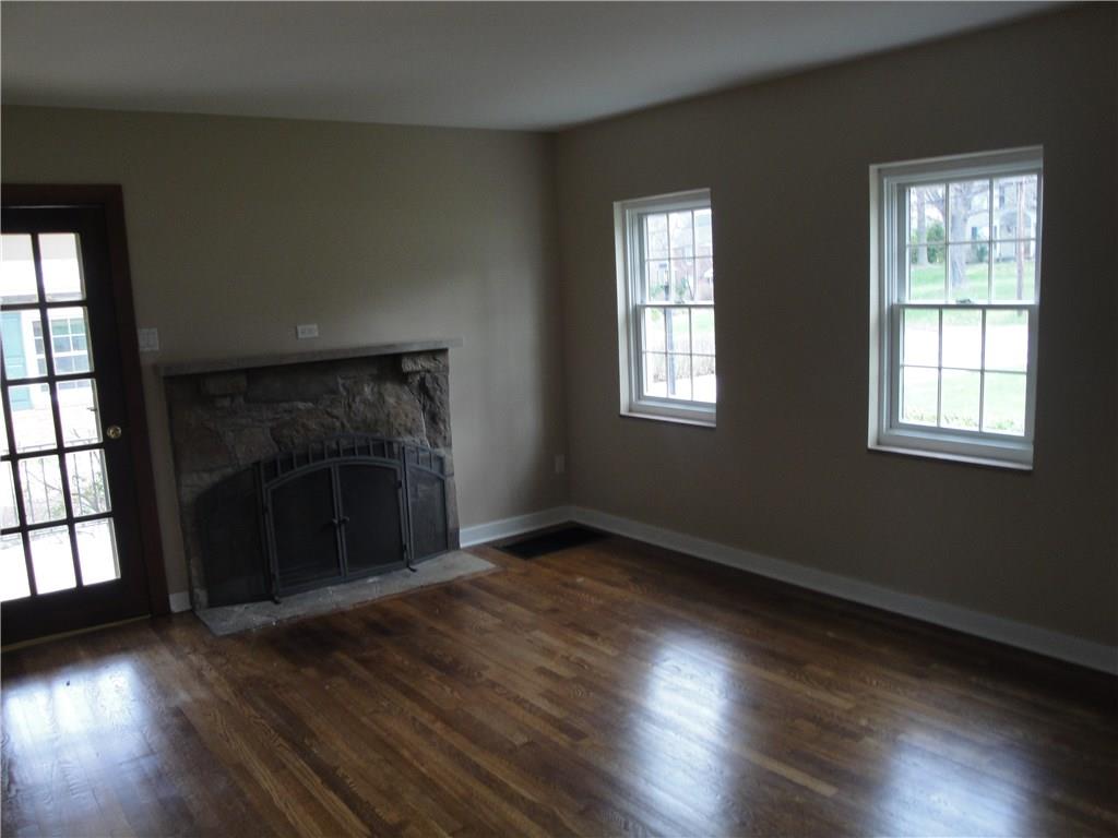 1256 Country Club Road Monongahela, PA 15063 - Photo 8 of 23 Living room has refinished hardwood flooring and a stone fireplace...
