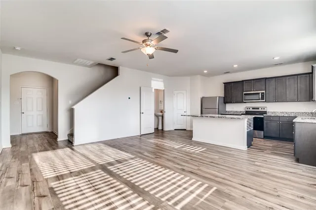 a view of kitchen with sink and refrigerator