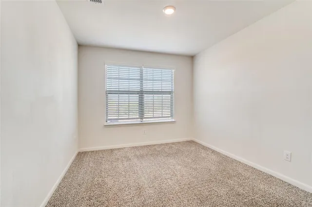 a kitchen with stainless steel appliances granite countertop a refrigerator a stove a sink and a microwave