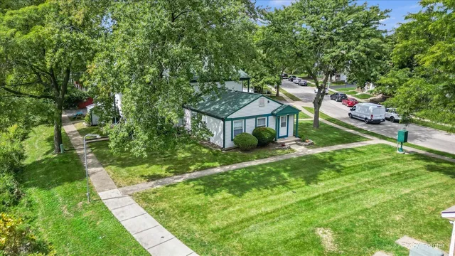 a backyard of a house with table and chairs
