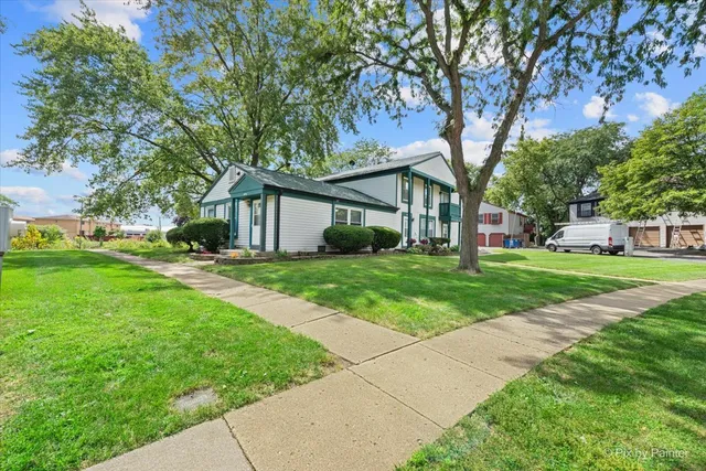 a view of house that has a yard