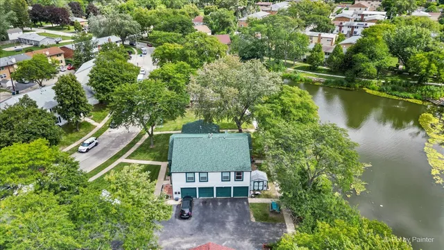 an aerial view of a house with a lake view