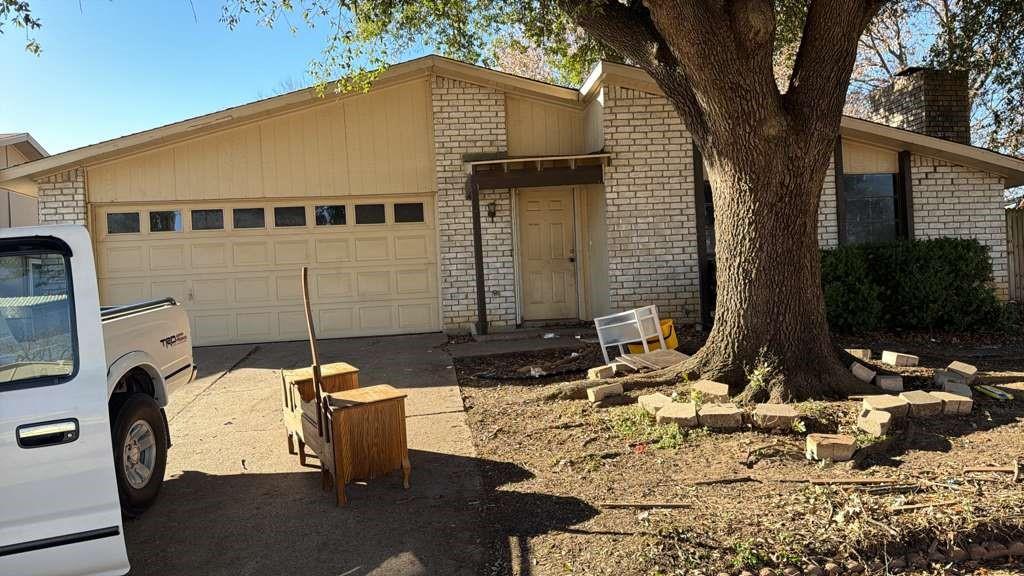 7200 Timber Trail Fort Worth, TX 76134 - Photo 2 of 18 a front view of a house with garden