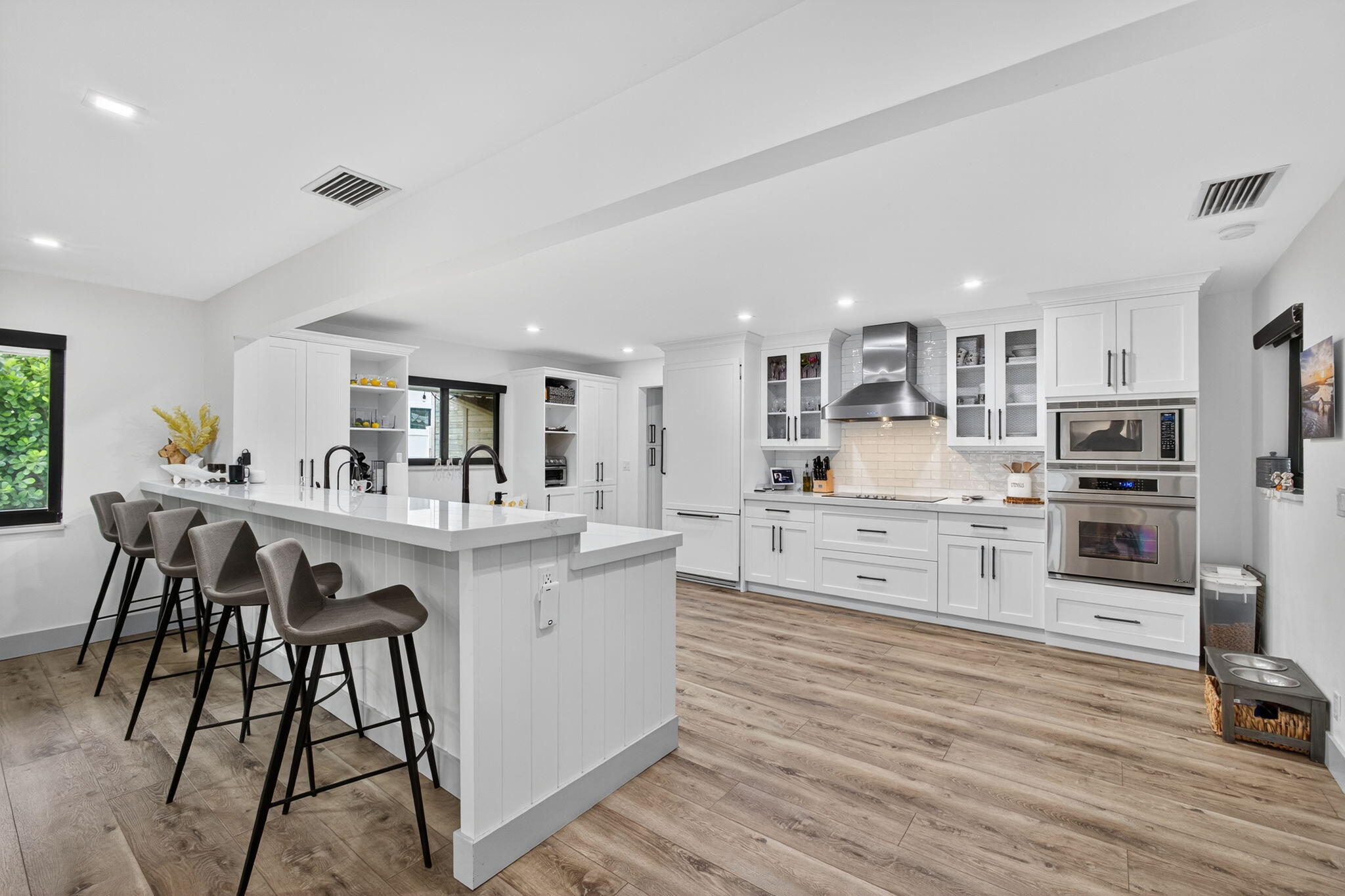 12 Leeward Circle Tequesta, FL 33469 - Photo 13 of 61 a kitchen with stainless steel appliances kitchen island granite countertop a sink and cabinets