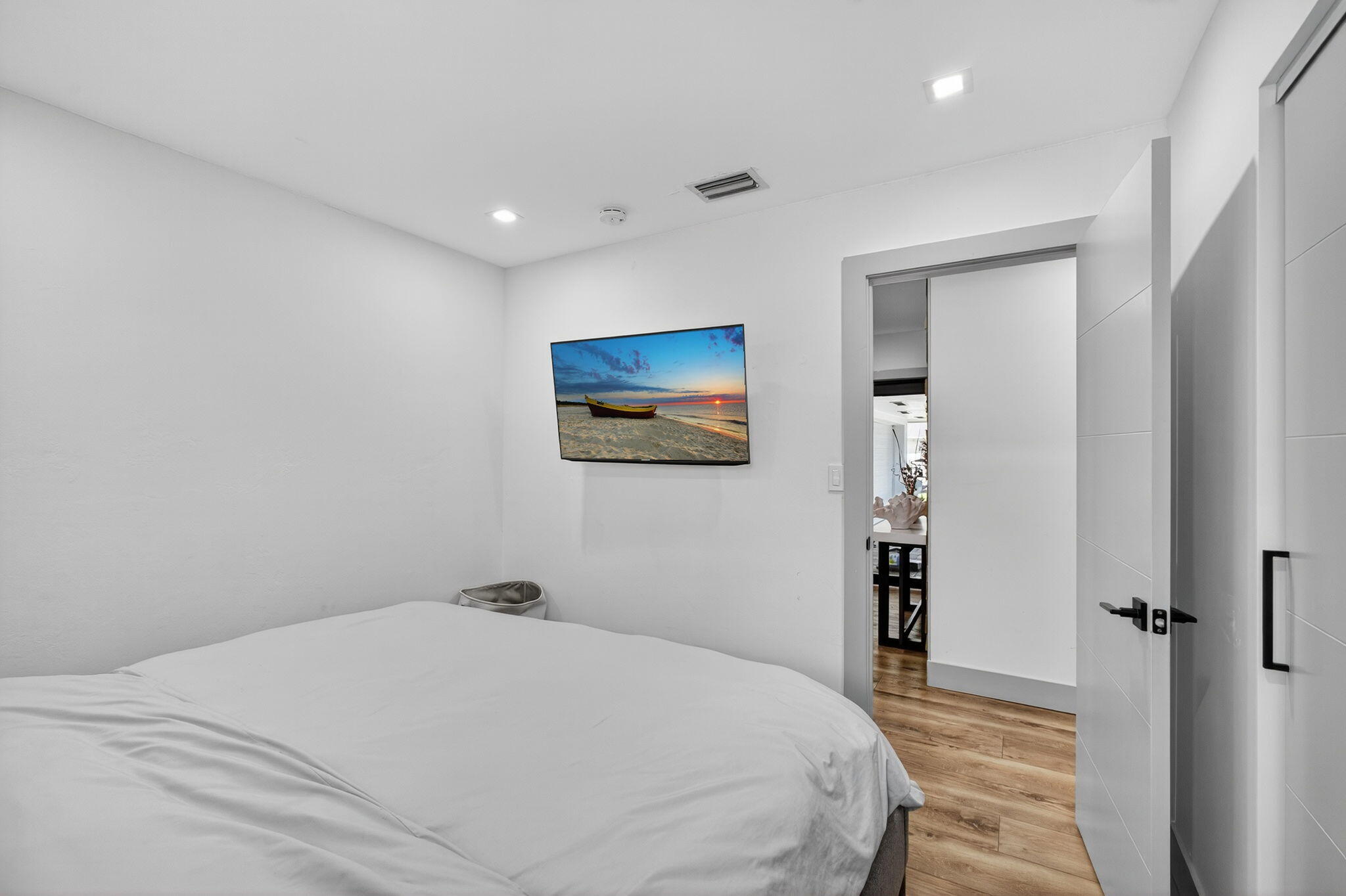 12 Leeward Circle Tequesta, FL 33469 - Photo 30 of 61 a bedroom with a large bed and a chandelier