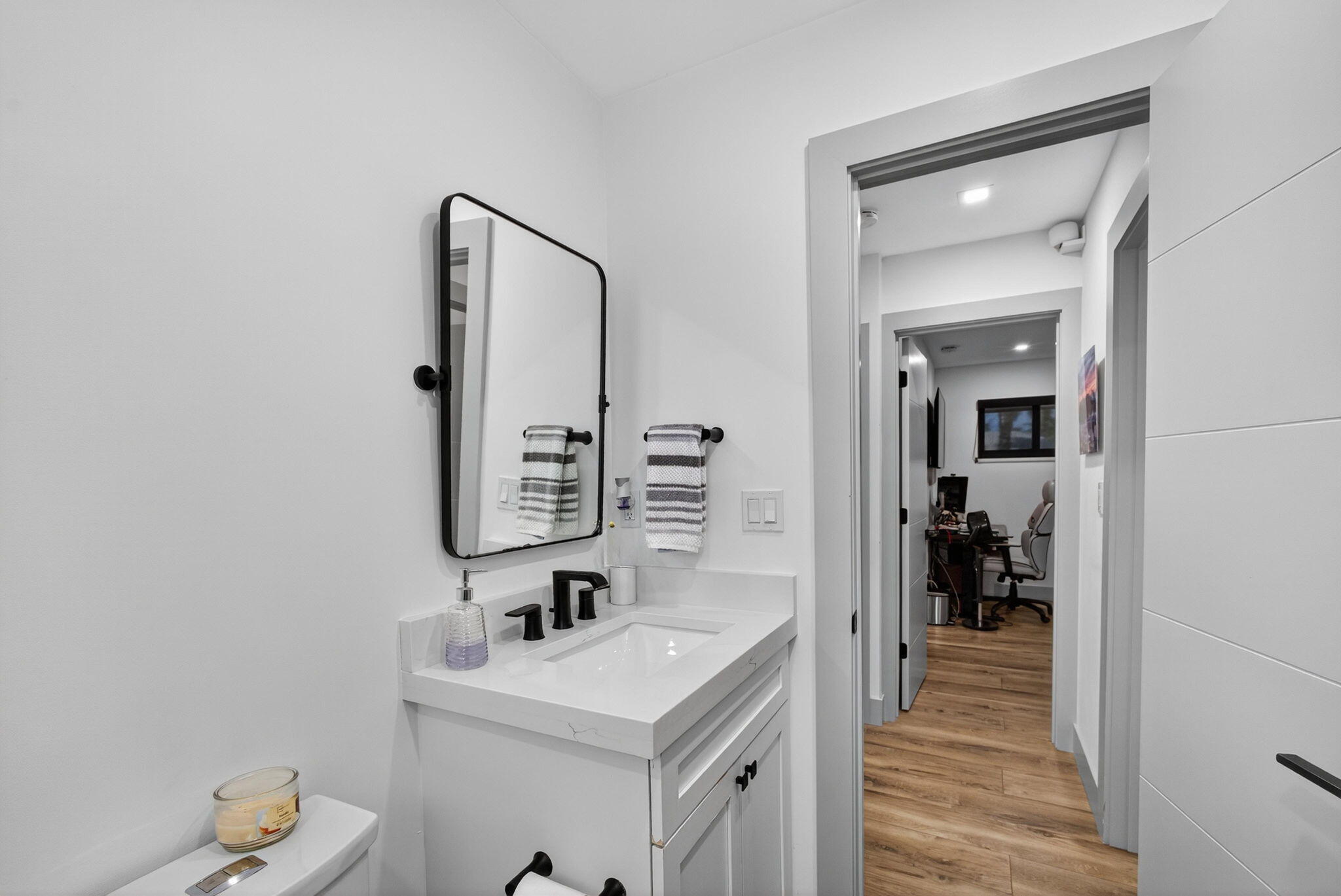 12 Leeward Circle Tequesta, FL 33469 - Photo 31 of 61 a bathroom with a sink a mirror and vanity