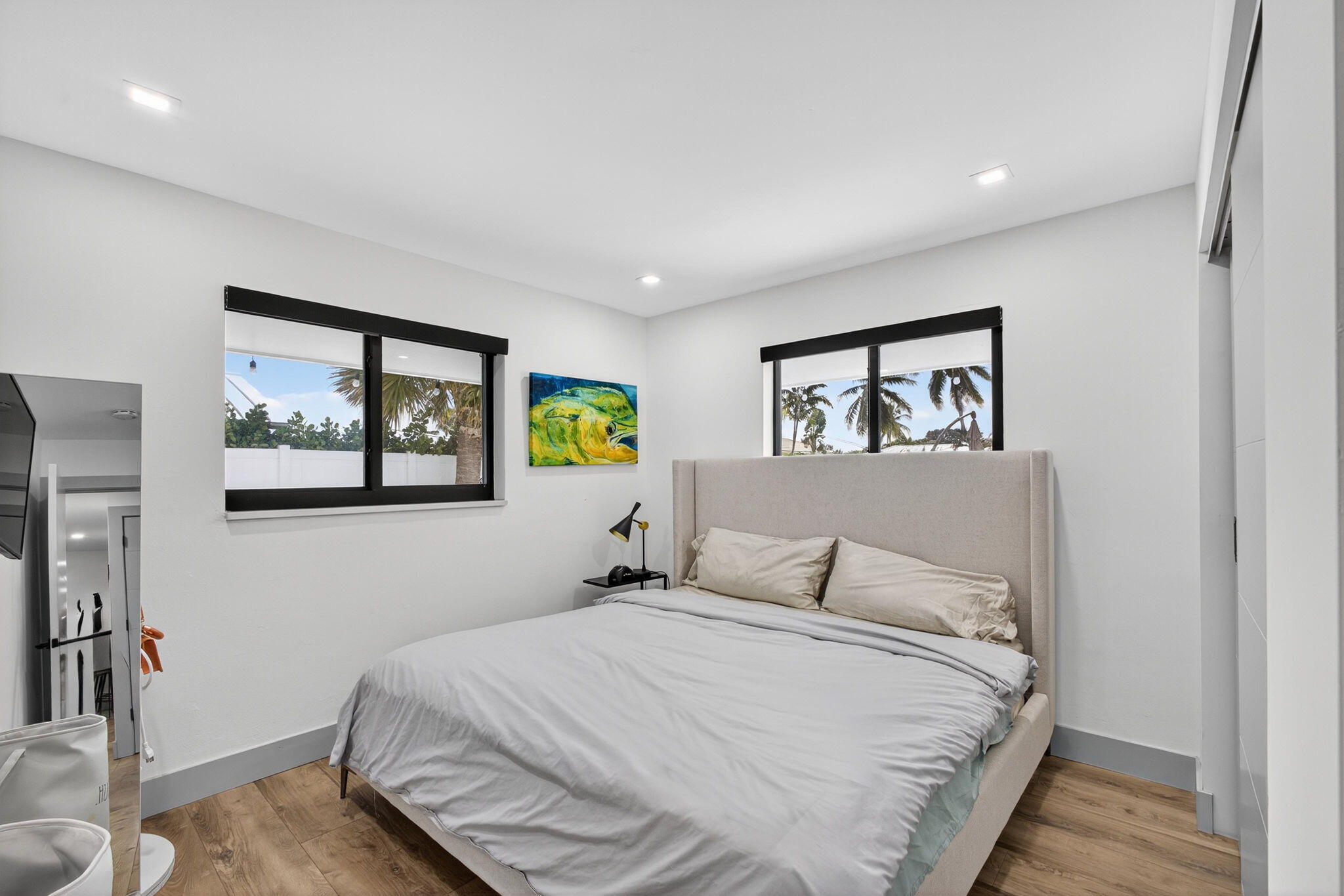 12 Leeward Circle Tequesta, FL 33469 - Photo 32 of 61 a bedroom with a bed and a painting on the wall