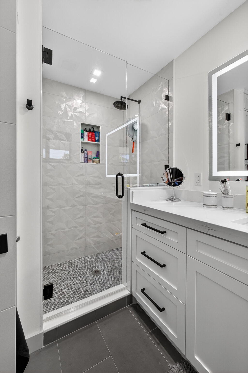 12 Leeward Circle Tequesta, FL 33469 - Photo 35 of 61 a bathroom with a shower sink and mirror