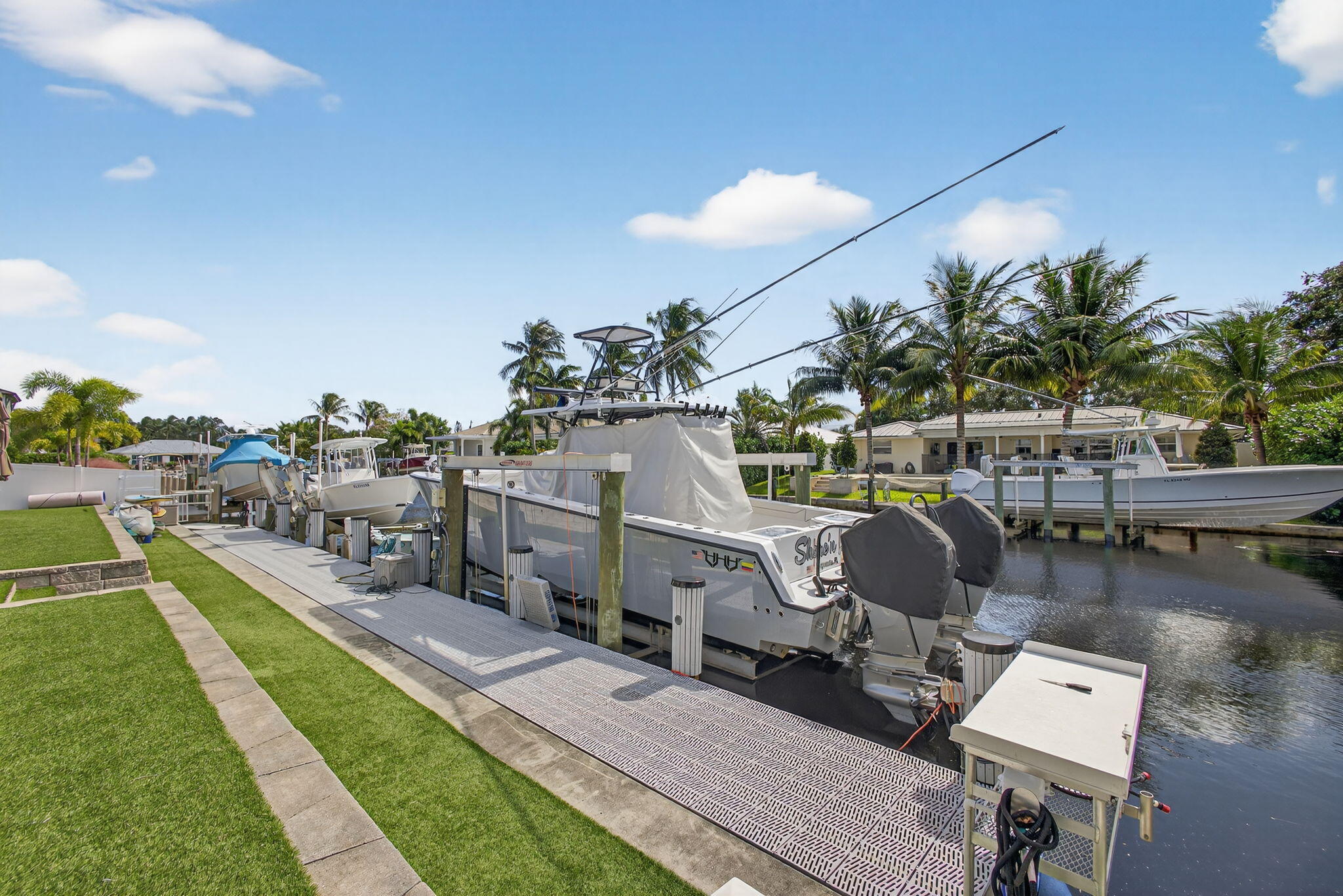 12 Leeward Circle Tequesta, FL 33469 - Photo 43 of 61 a view of a chairs and table in patio with a yard