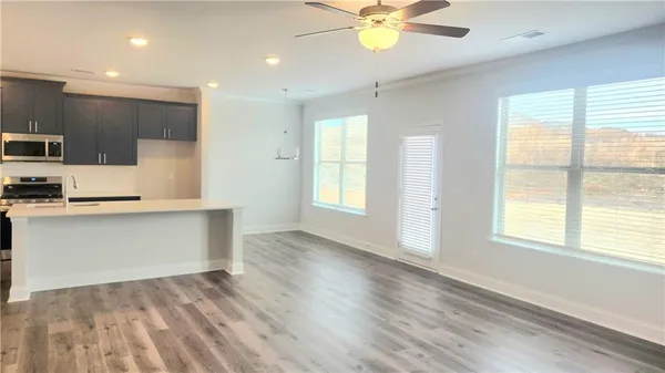 a view of kitchen with sink and wooden floor