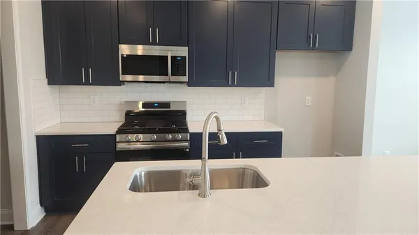 a kitchen with a sink and a microwave