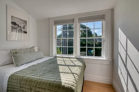 a bedroom with a large bed and a large window