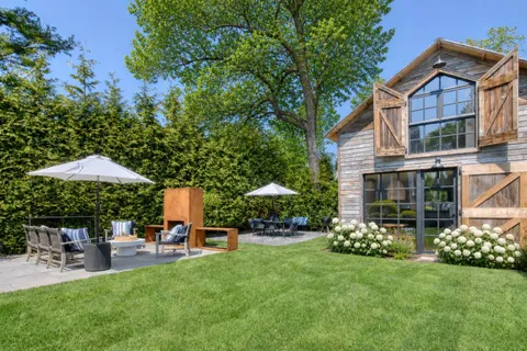 a view of a house with backyard porch and sitting area