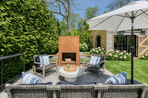 a view of a patio with table and chairs potted plants with wooden floor