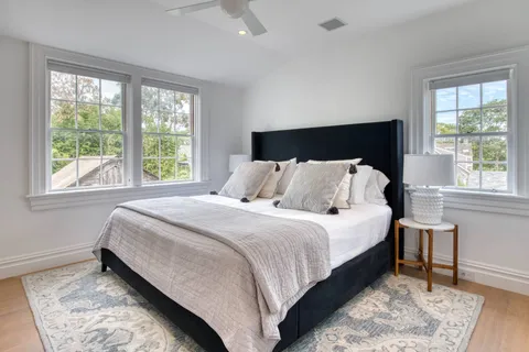 a bedroom with bed and window