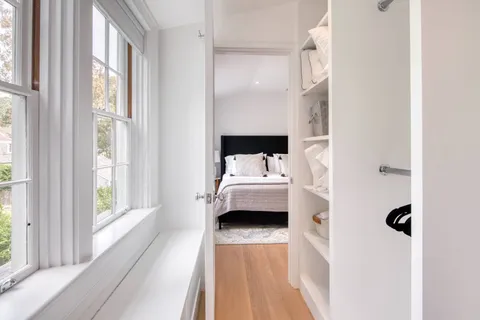 a view of bedroom with window and walk in closet