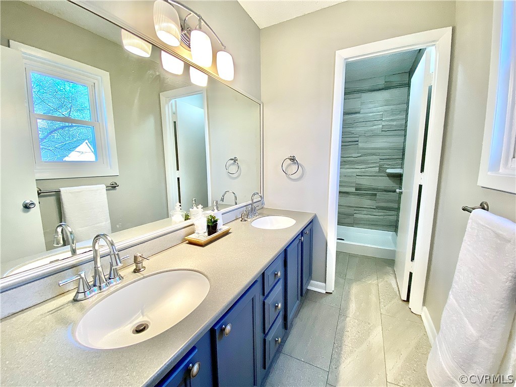 14120 Ridge Creek Road Midlothian, VA 23112 - Photo 21 of 30 a bathroom with a double vanity sink a mirror and a bathtub