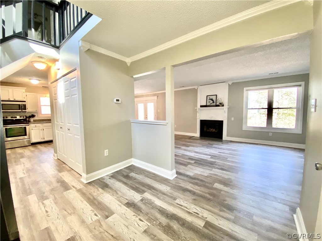 14120 Ridge Creek Road Midlothian, VA 23112 - Photo 4 of 30 a view of a livingroom with wooden floor and kitchen space