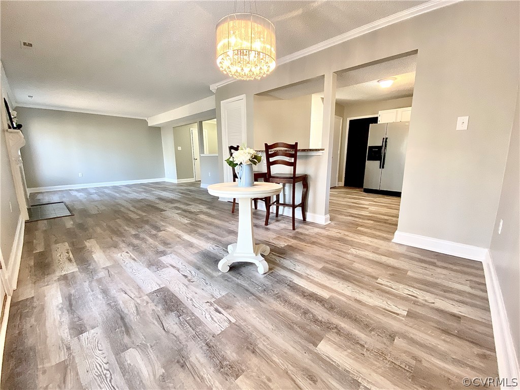 14120 Ridge Creek Road Midlothian, VA 23112 - Photo 7 of 30 a view of a dining room with furniture a chandelier and wooden floor
