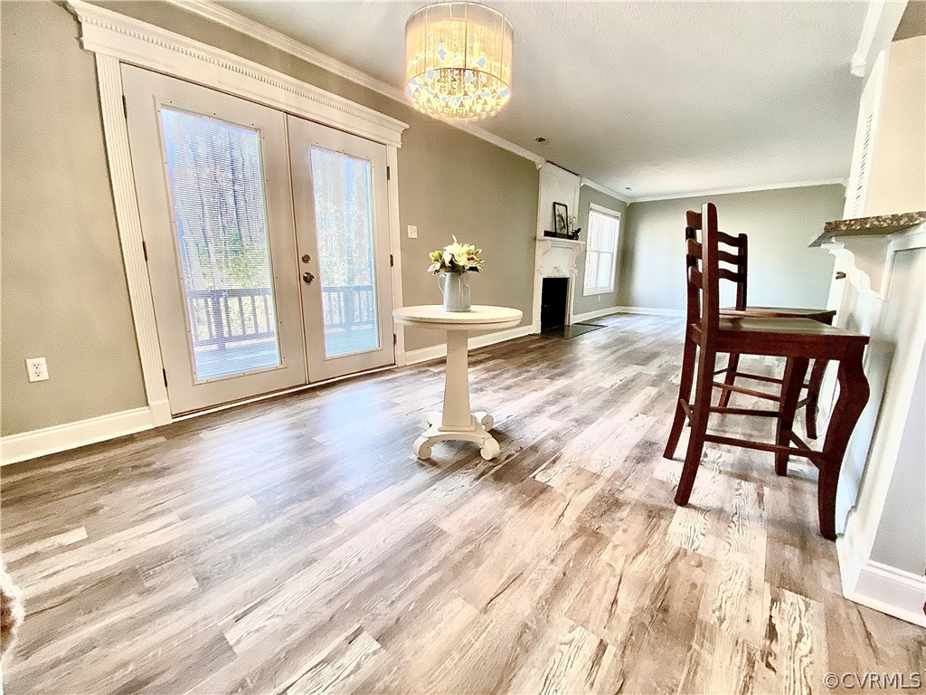 14120 Ridge Creek Road Midlothian, VA 23112 - Photo 9 of 30 a dining room with wooden floor a chandelier a wooden table and chairs