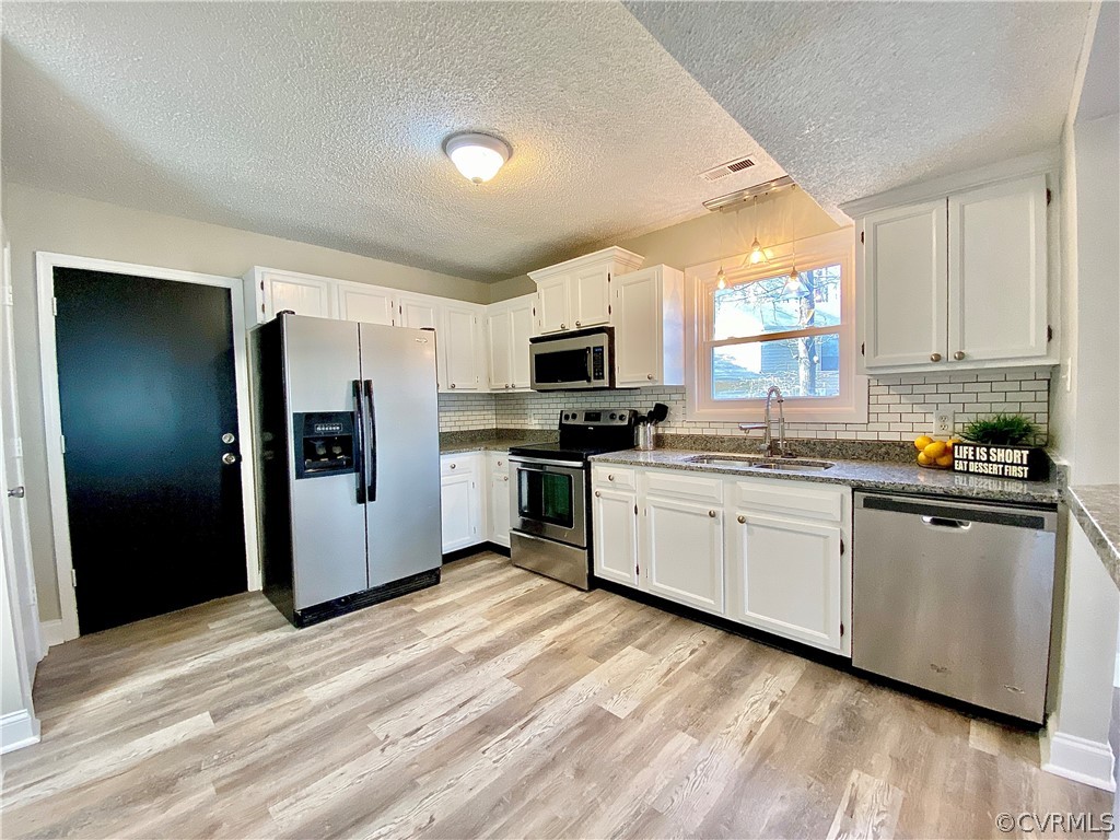 14120 Ridge Creek Road Midlothian, VA 23112 - Photo 10 of 30 a kitchen with granite countertop white cabinets and stainless steel appliances
