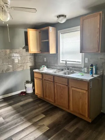 a kitchen with a sink cabinets and window