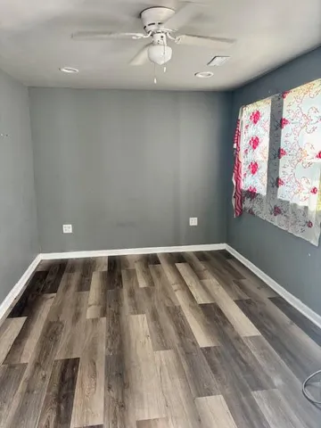 a view of room with window and ceiling fan