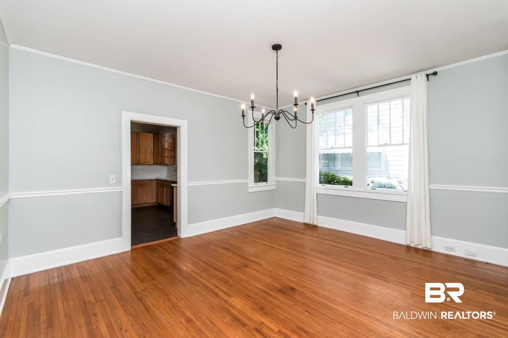 10 Macy Place Mobile, AL 36604 - Photo 9 of 43 Unfurnished dining area with a chandelier, hardwood / wood-style floors, and crown molding