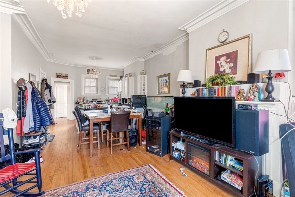 124 F Street Boston, MA 02127 - Photo 11 of 28 a living room with furniture and a flat screen tv